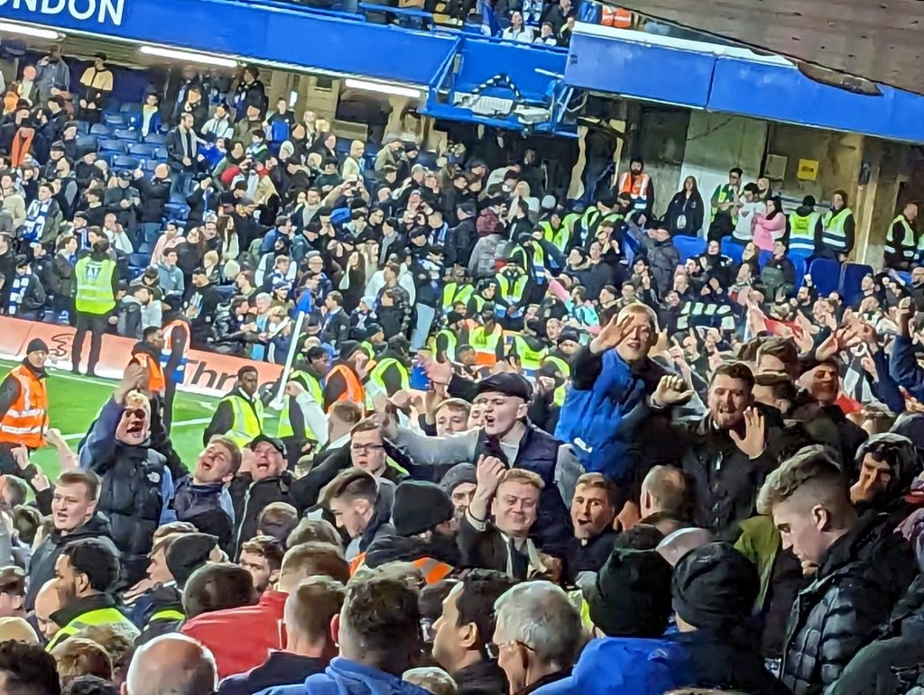A view of away fans making rude gestures at Stamford Bridge