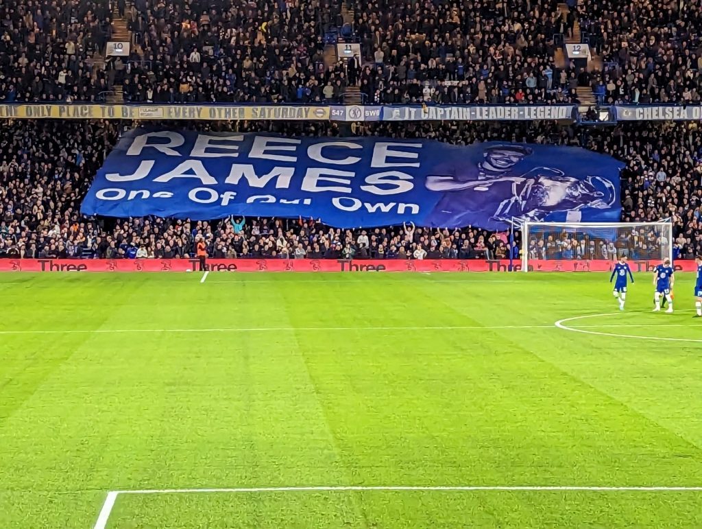 Fan Banner of Reece James displayed before a game at Stamford Bridge reading "Reece James He's One Of Our Own"